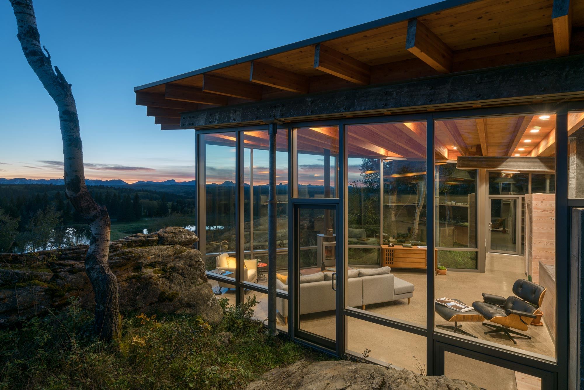 Warm interior of Rock House as sun sets over Carraig Ridge